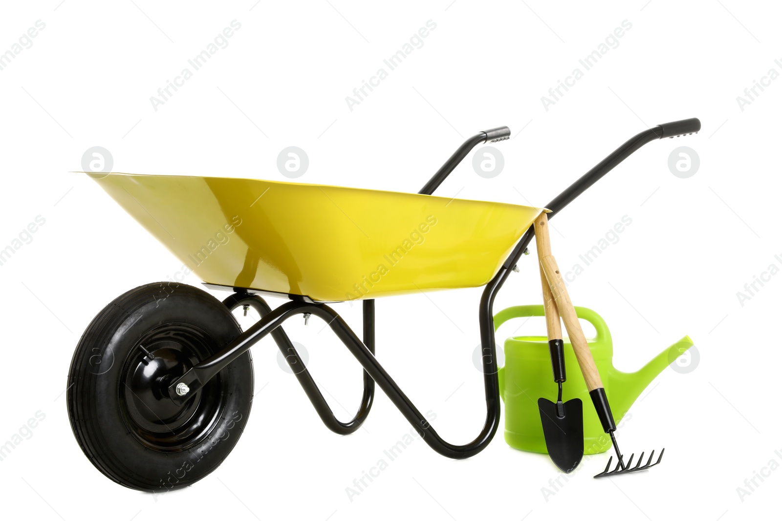 Photo of Wheelbarrow with gardening tools isolated on white