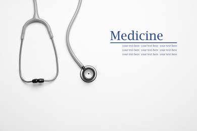 Stethoscope on white background, top view. Space for text