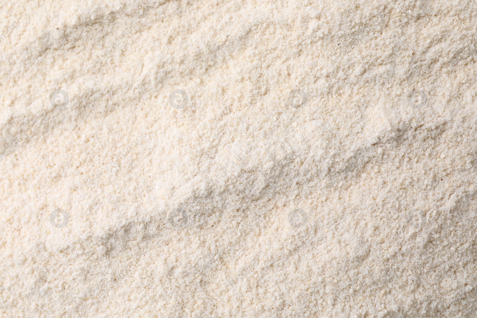 Photo of Heap of quinoa flour as background, closeup