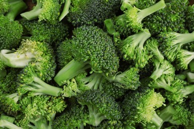 Photo of Fresh raw broccoli as background, top view