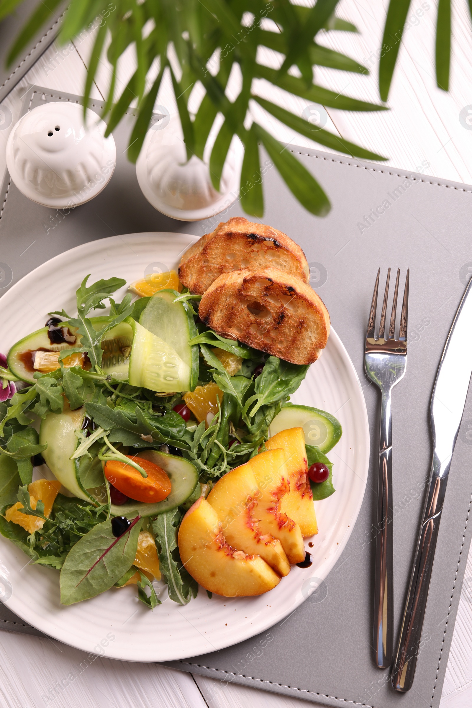 Photo of Delicious salad with fruits and vegetables served on white wooden table, flat lay