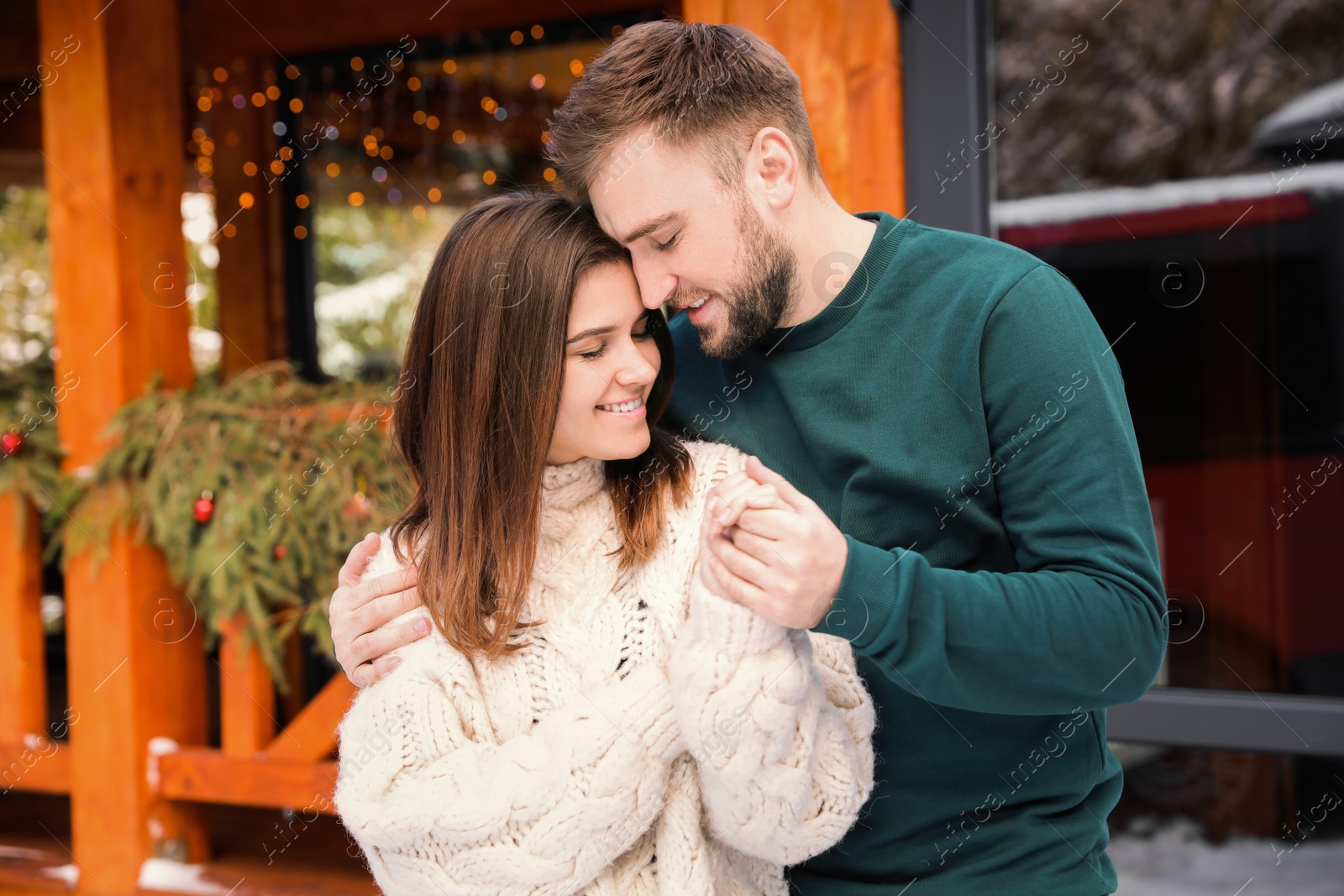 Photo of Happy couple in warm clothes outdoors. Winter vacation