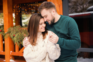 Happy couple in warm clothes outdoors. Winter vacation