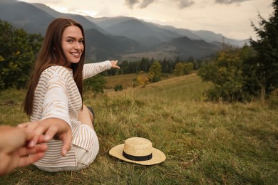 Photo of Young woman showing her boyfriend view on beautiful mountains. Space for text