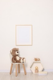 Beautiful children's room with light wall, furniture and toys. Interior design