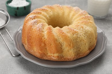 Photo of Delicious freshly baked sponge cake on gray table, closeup