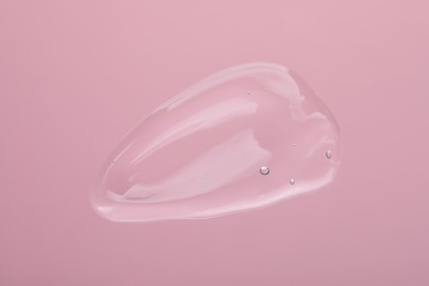 Photo of Sample of cleansing gel on pink background, top view. Cosmetic product