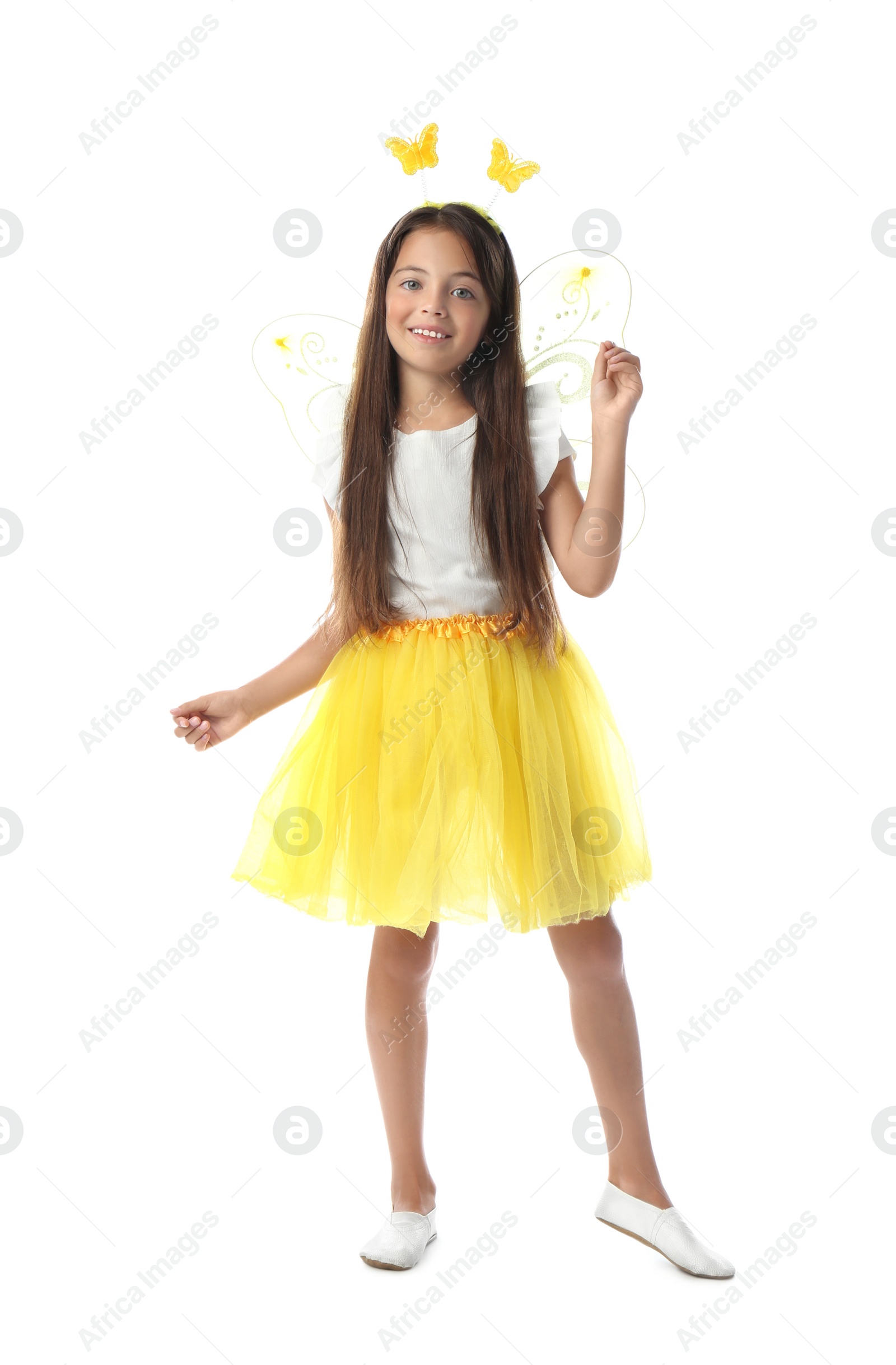 Photo of Cute little girl in fairy costume with yellow wings on white background