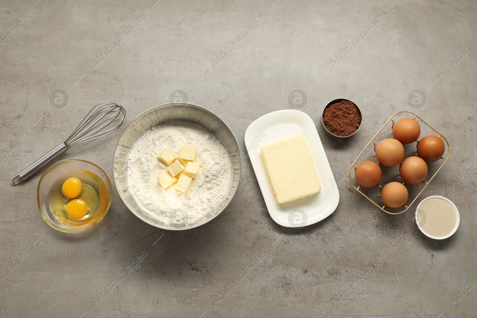 Photo of Flat lay composition with fresh butter and other products on grey textured table