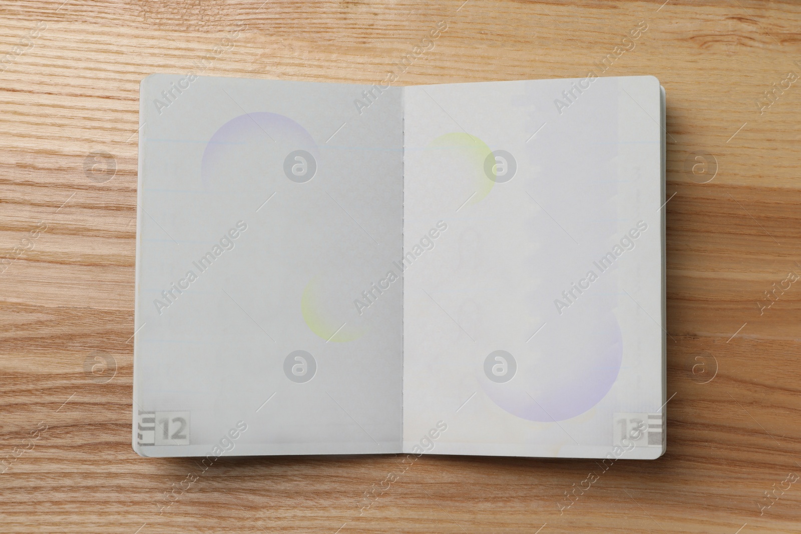 Photo of Blank open passport on wooden table, top view