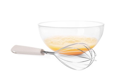 Beaten eggs in glass bowl and whisk isolated on white