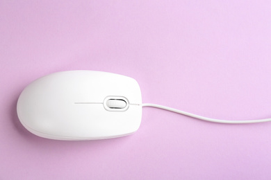 Modern wired optical mouse on lilac background, top view