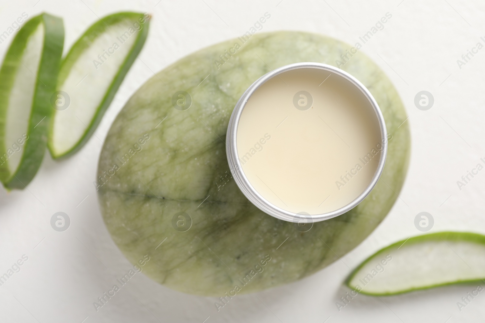 Photo of Lip balm and aloe vera plant on white background, flat lay