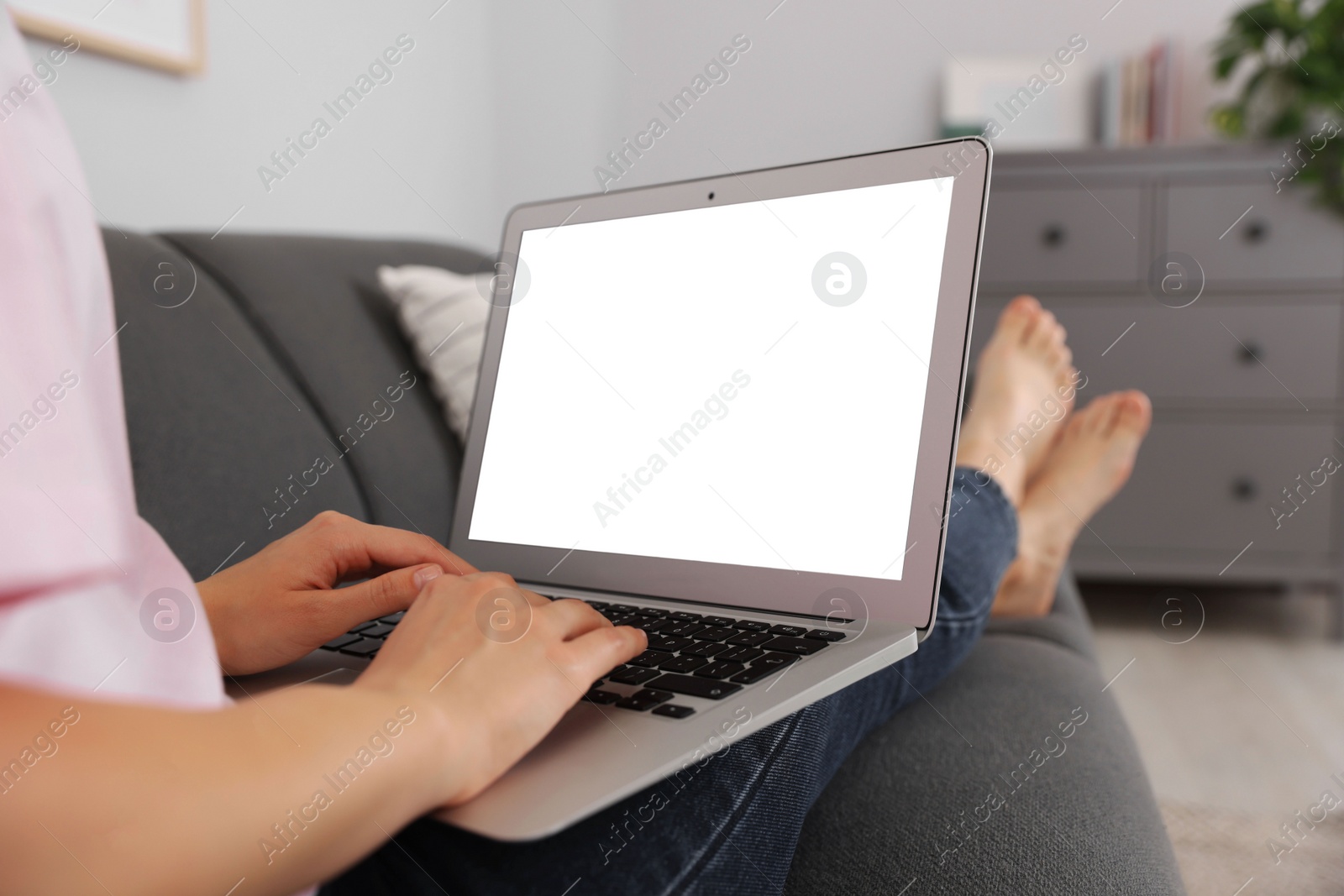 Photo of Woman with laptop on sofa at home, closeup