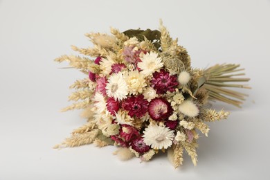 Beautiful bouquet of dry flowers on white background