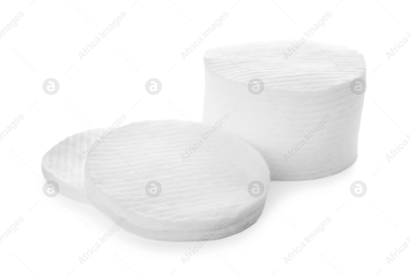 Photo of Piles of cotton pads on white background