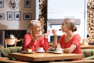 Photo of Mother and her adult daughter spending time together in cafe
