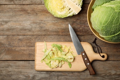 Photo of Flat lay composition with savoy cabbages on kitchen table