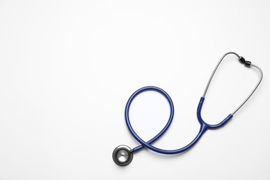 Photo of Stethoscope on white background, top view. Space for text
