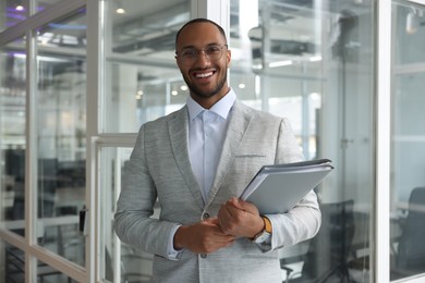 Photo of Happy man with folders in office. Lawyer, businessman, accountant or manager