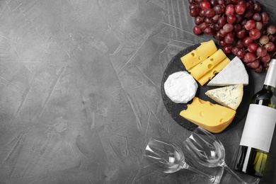 Photo of Flat lay composition with wine, snacks and space for text on grey background