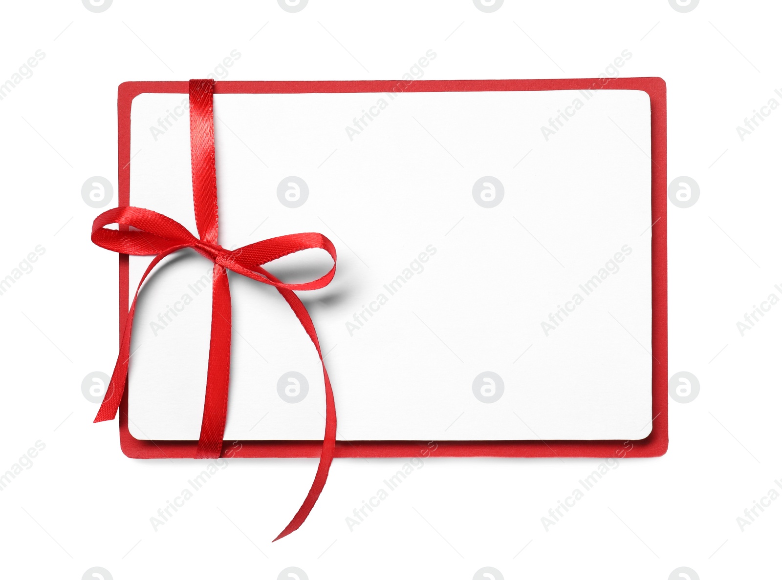 Photo of Blank gift card with red bow isolated on white, top view