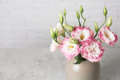Photo of Beautiful flowers in vase as element of interior design on table. Space for text