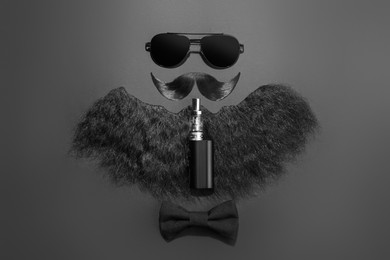 Flat lay composition with artificial moustache and beard on black background