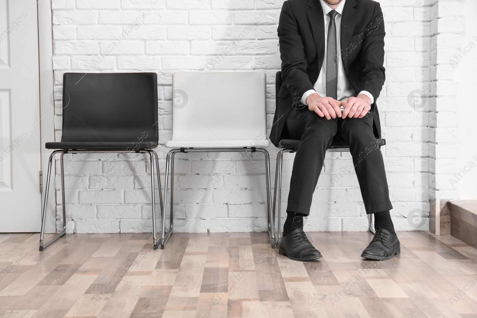 Photo of Young man waiting for job interview, indoors