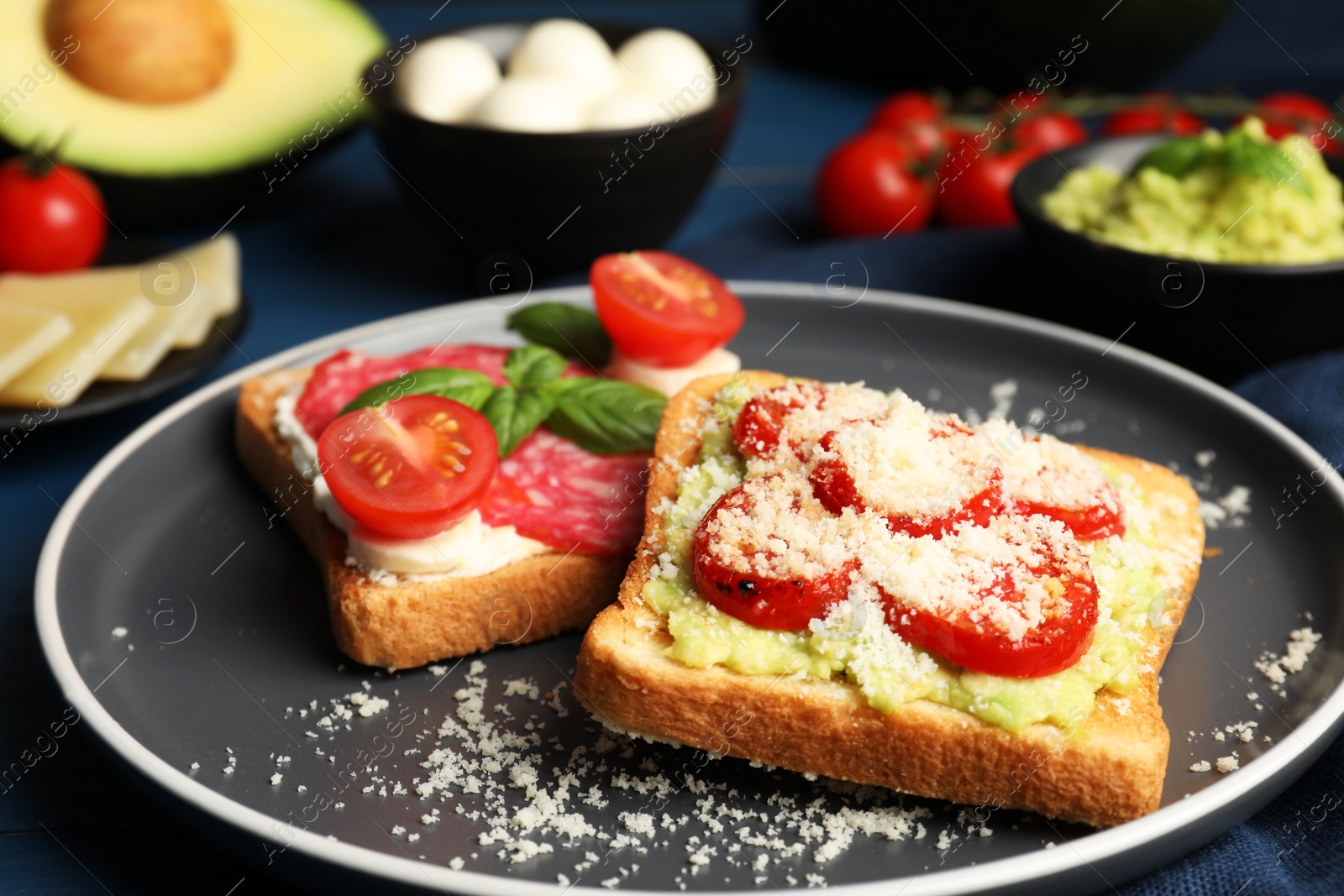 Photo of Tasty toasts with different toppings served on table, closeup