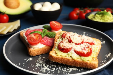 Photo of Tasty toasts with different toppings served on table, closeup