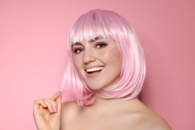 Photo of Happy woman with bright makeup and fake freckles on pink background