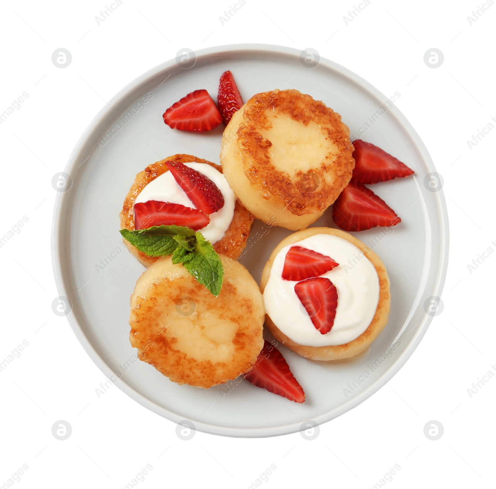 Photo of Delicious cottage cheese pancakes with strawberries, honey and sour cream on white background, top view