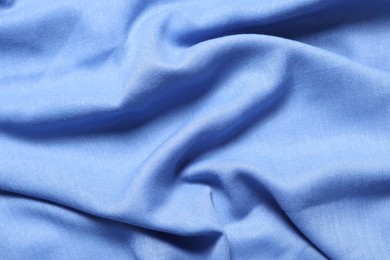 Photo of Texture of light blue crumpled fabric as background, top view