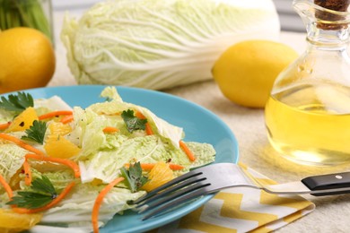 Tasty salad with Chinese cabbage, products and fork on table, closeup