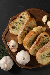 Tasty baguette with garlic and dill on grey table, top view