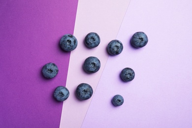 Flat lay composition with tasty blueberry on color background