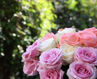 Photo of Beautiful bouquet of aromatic roses outdoors, closeup
