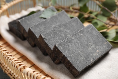 Natural tar soap in wicker basket, closeup