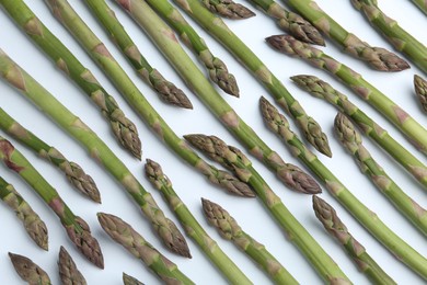 Photo of Fresh raw asparagus on white background, above view