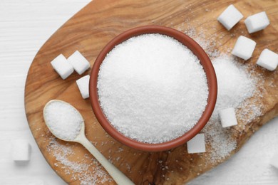 Different types of sugar on white wooden table, flat lay