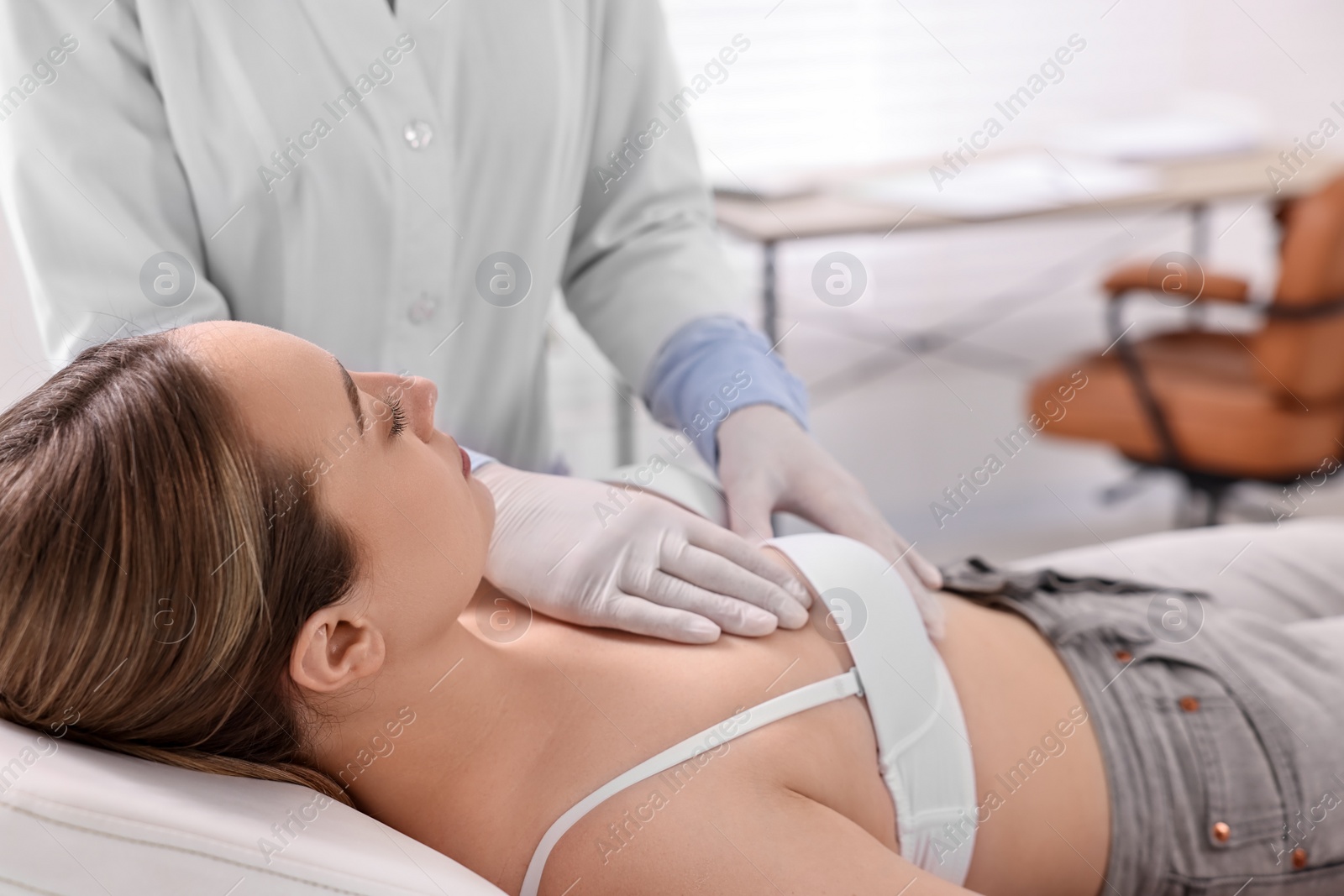 Photo of Mammologist checking young woman's breast in hospital