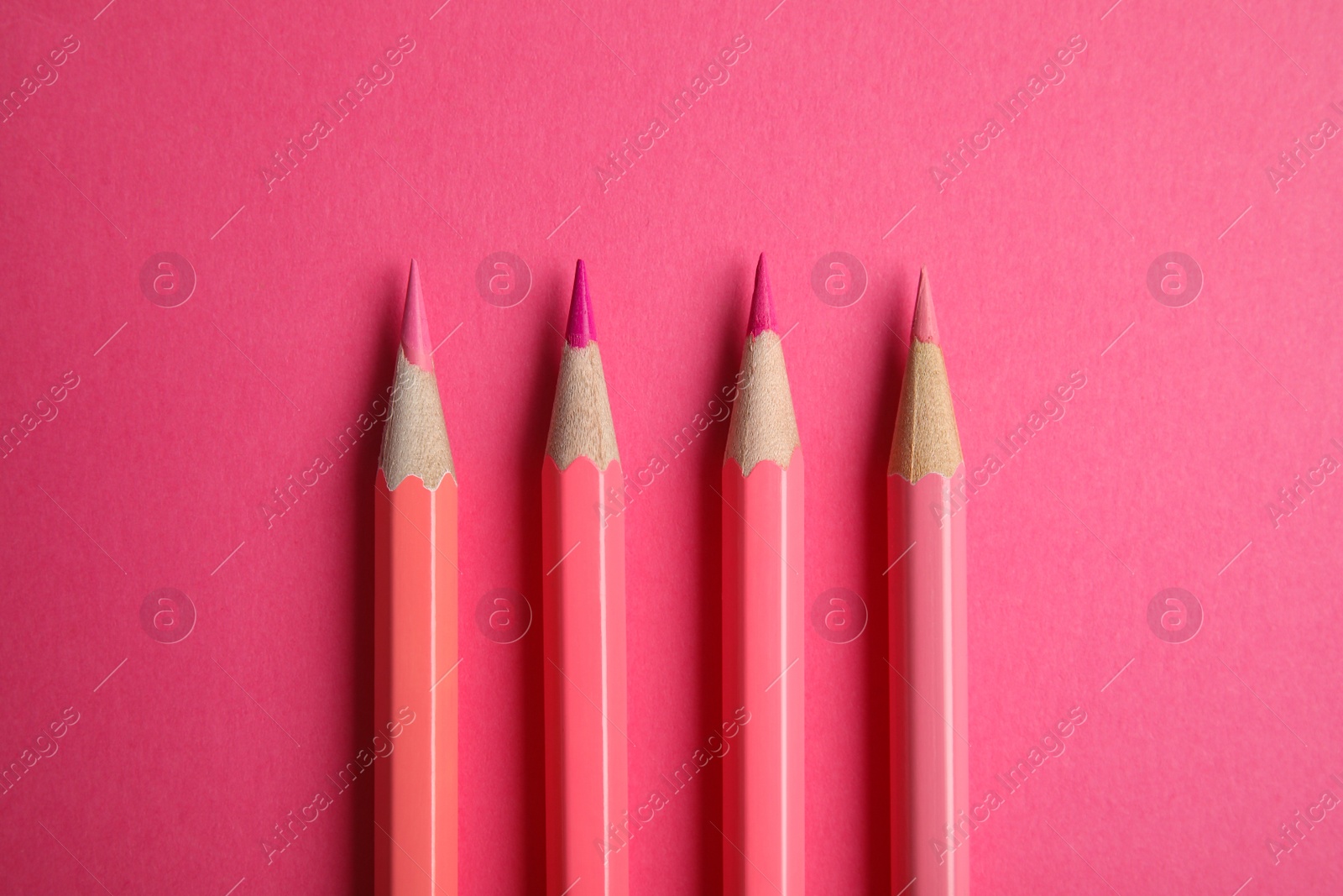 Photo of Flat lay composition with color pencils on pink background