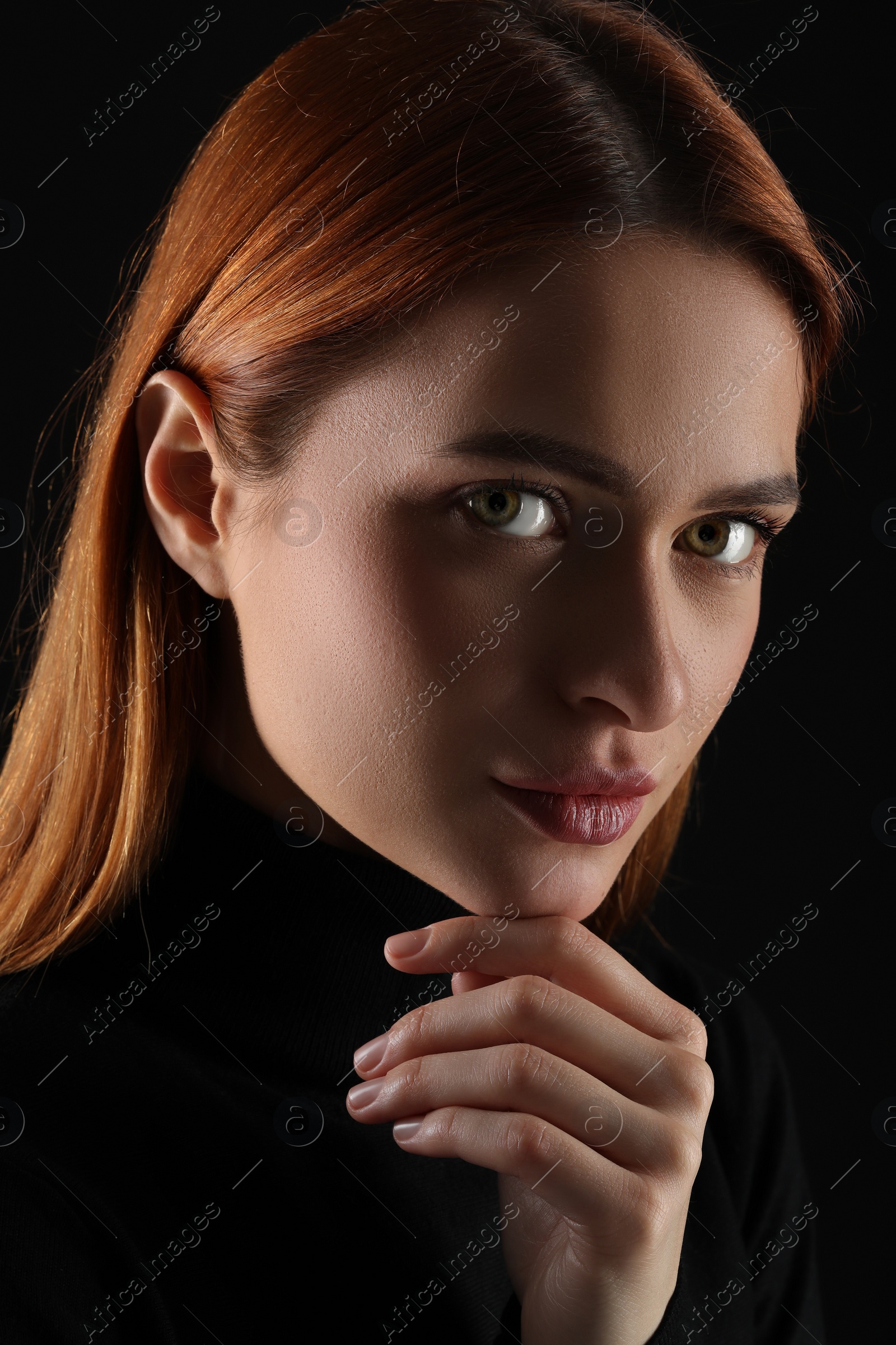 Photo of Evil eye. Young woman with scary eyes on black background