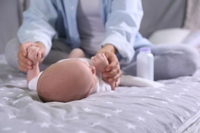 Photo of Mother and her little baby on bed, closeup