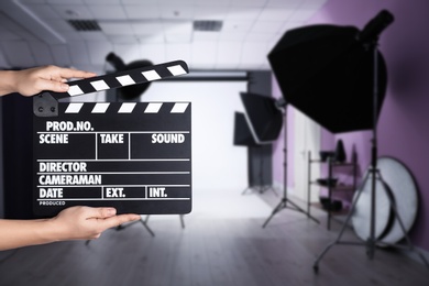 Assistant holding clapperboard on filming location, closeup. Cinema production 