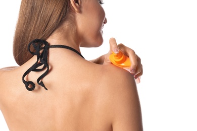 Photo of Woman applying sun protection body cream on white background, closeup