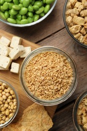 Photo of Different organic soy products on wooden table, flat lay