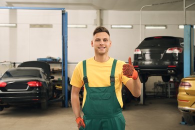 Portrait of professional mechanic at automobile repair shop