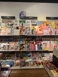Photo of WARSAW, POLAND - JULY 23, 2022: Rack with different magazines in store